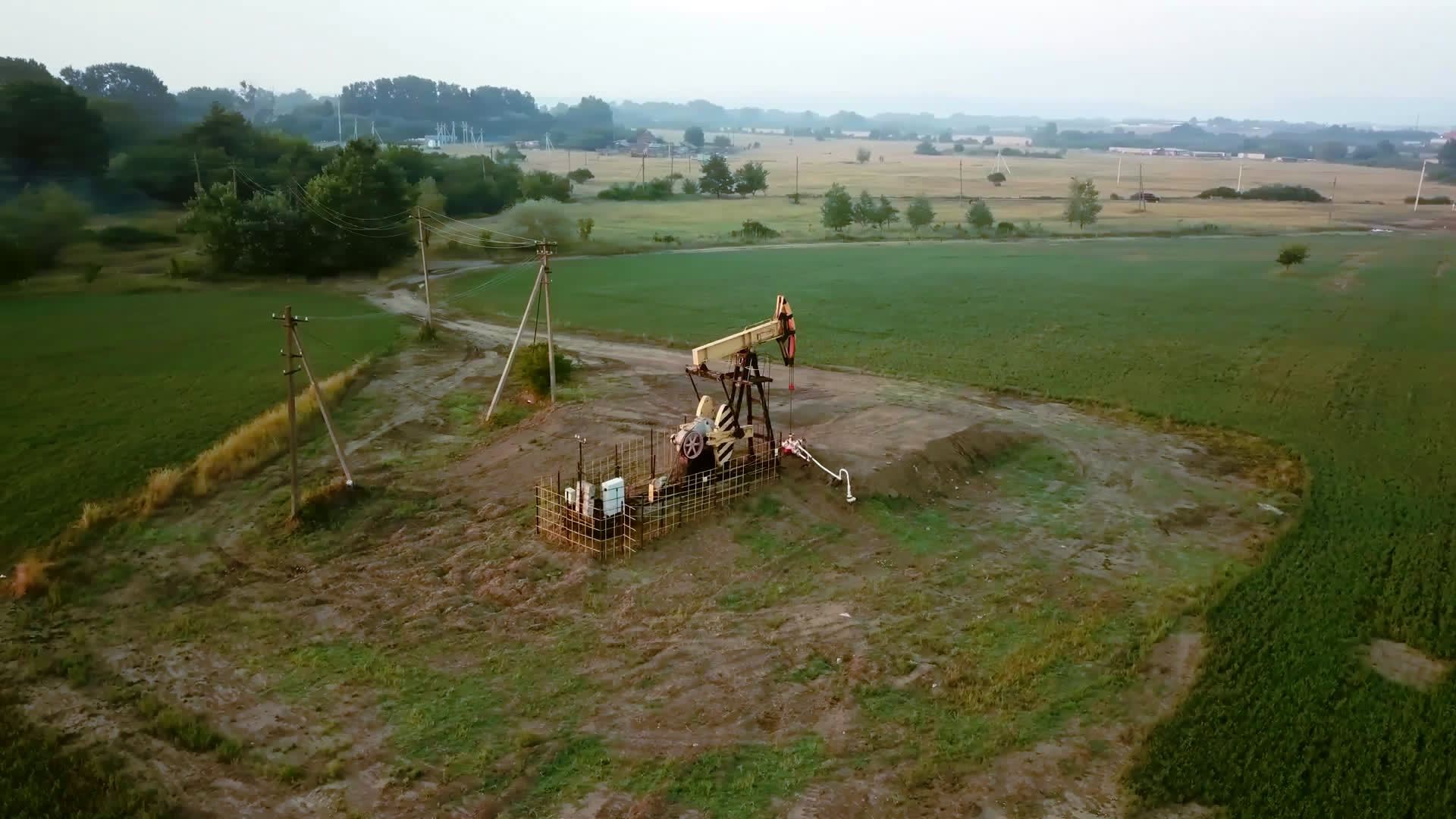 Pumpjack operating in a farmland field